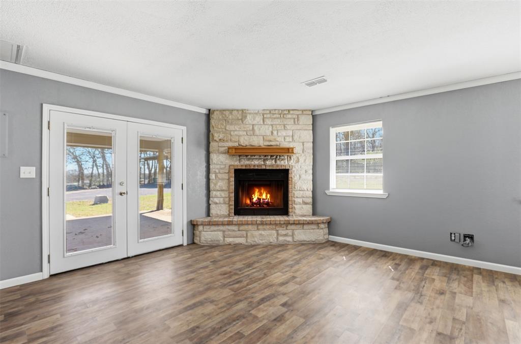 533 Eagles Way Springtown, TX 76082 - Photo 9 of 32 a view of an empty room with a window and fireplace