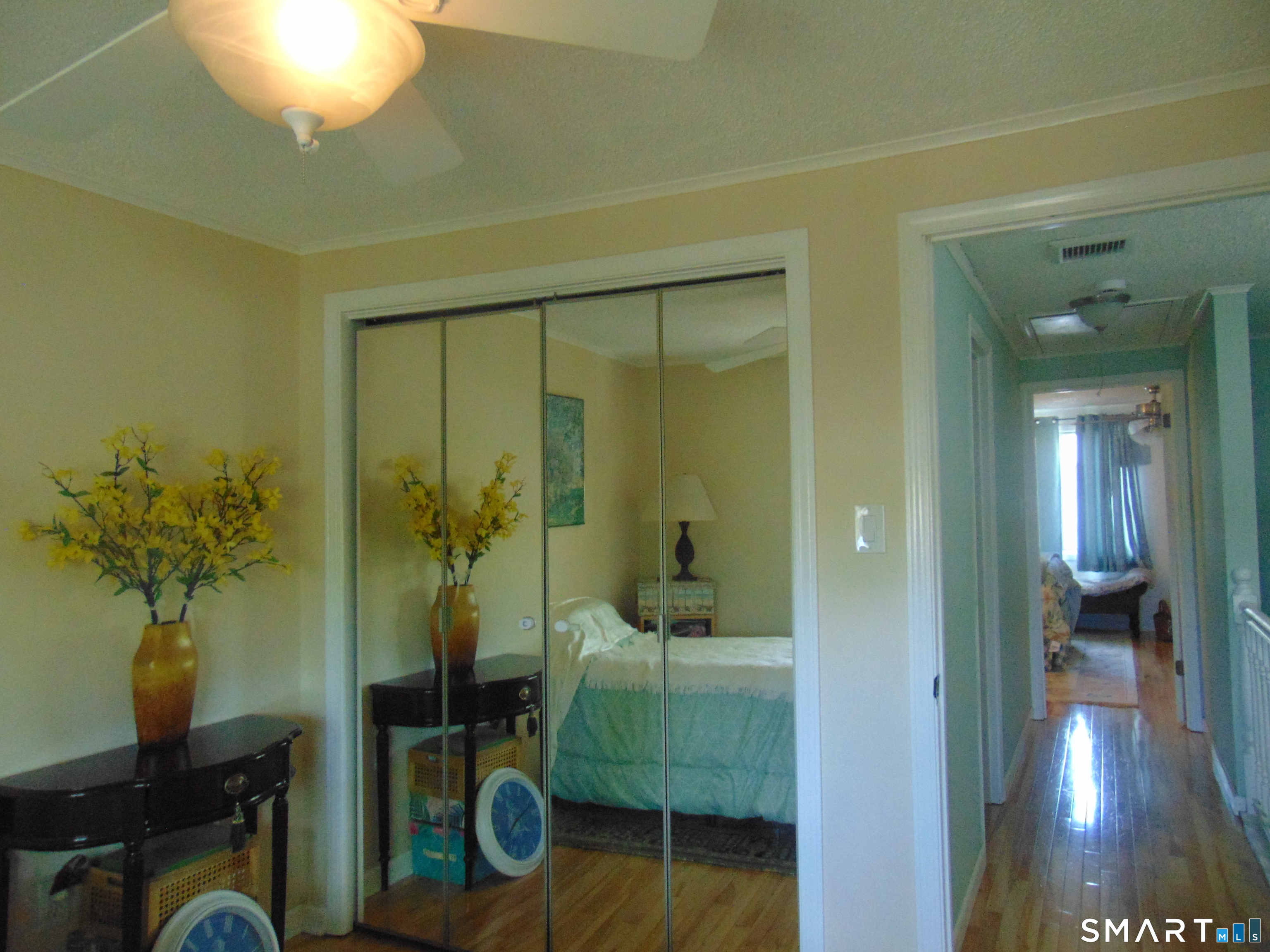 882 North Colony Road, Unit 31 Meriden, CT 06450 - Photo 26 of 34 a view of a hallway to a livingroom with furniture and a potted plant