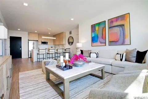 a living room with furniture and wooden floor