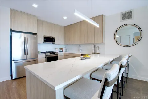 a kitchen with a table chairs a sink a refrigerator and a stove