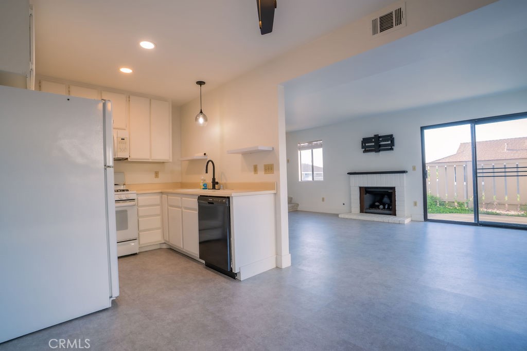 1153 Sumner Place, Unit D Santa Maria, CA 93455 - Photo 12 of 33 a view of a kitchen with a sink and a fireplace