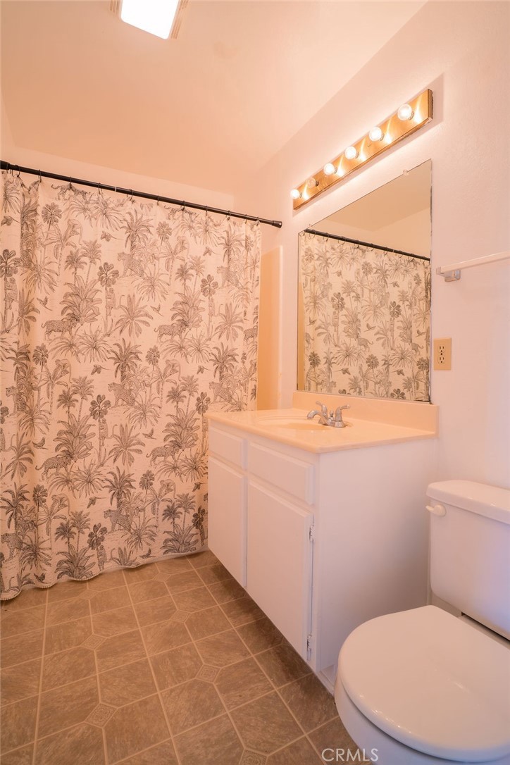 1153 Sumner Place, Unit D Santa Maria, CA 93455 - Photo 25 of 33 a bathroom with a toilet a sink and a window
