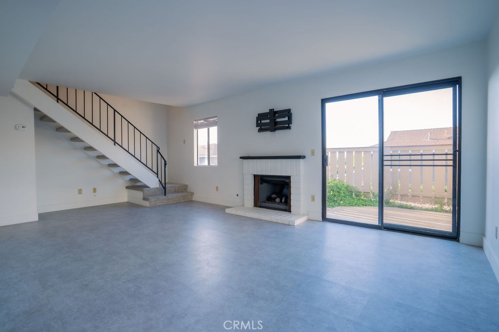1153 Sumner Place, Unit D Santa Maria, CA 93455 - Photo 6 of 33 a view of empty room with fireplace and windows