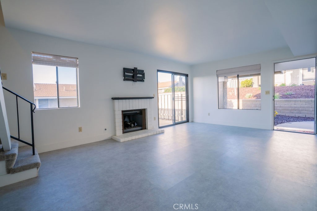 1153 Sumner Place, Unit D Santa Maria, CA 93455 - Photo 9 of 33 an empty room with windows and fireplace
