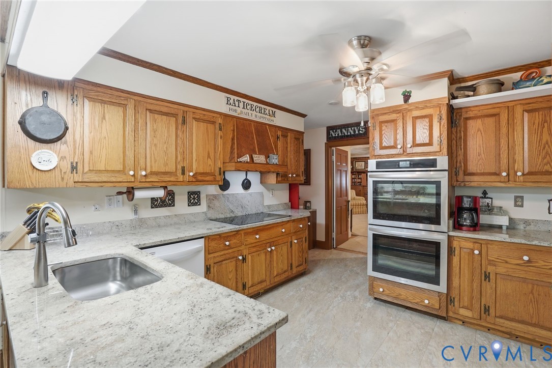 11016 Pridesville Road Amelia Court House, VA 23002 - Photo 26 of 54 a kitchen with stainless steel appliances granite countertop a sink and dishwasher a oven with granite countertops