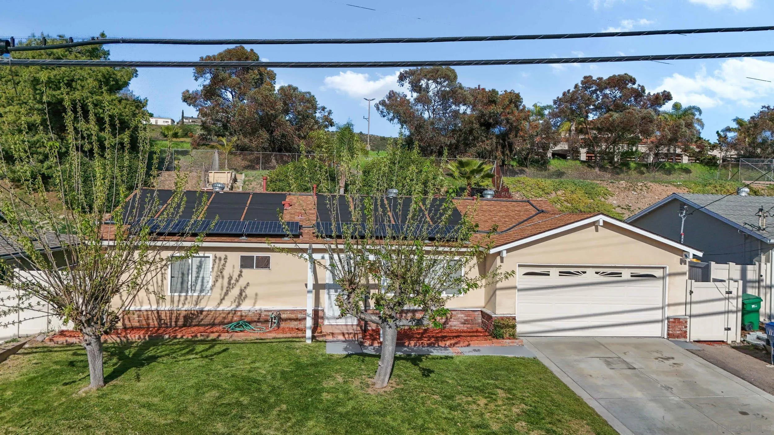 a view of a house with a yard fire pit and outdoor seating
