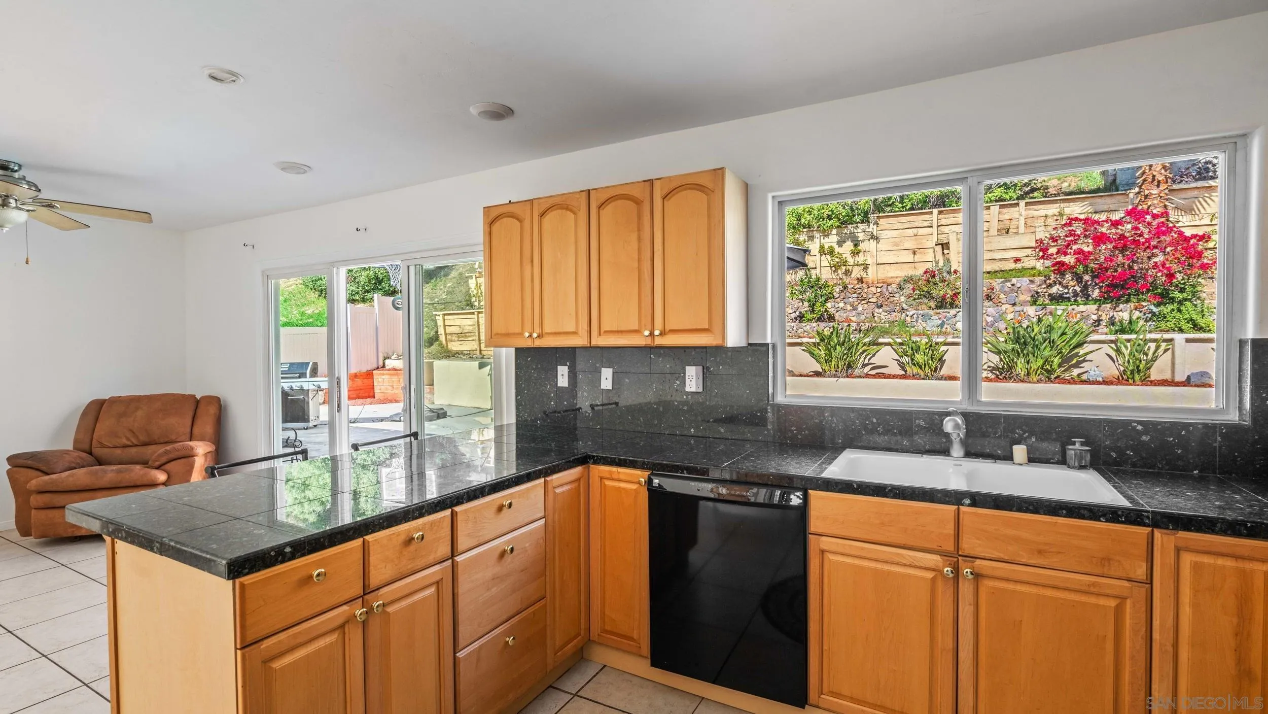 10019 Settle Road Santee, CA 92071 - Photo 13 of 35 a kitchen with granite countertop sink stove and granite counter top