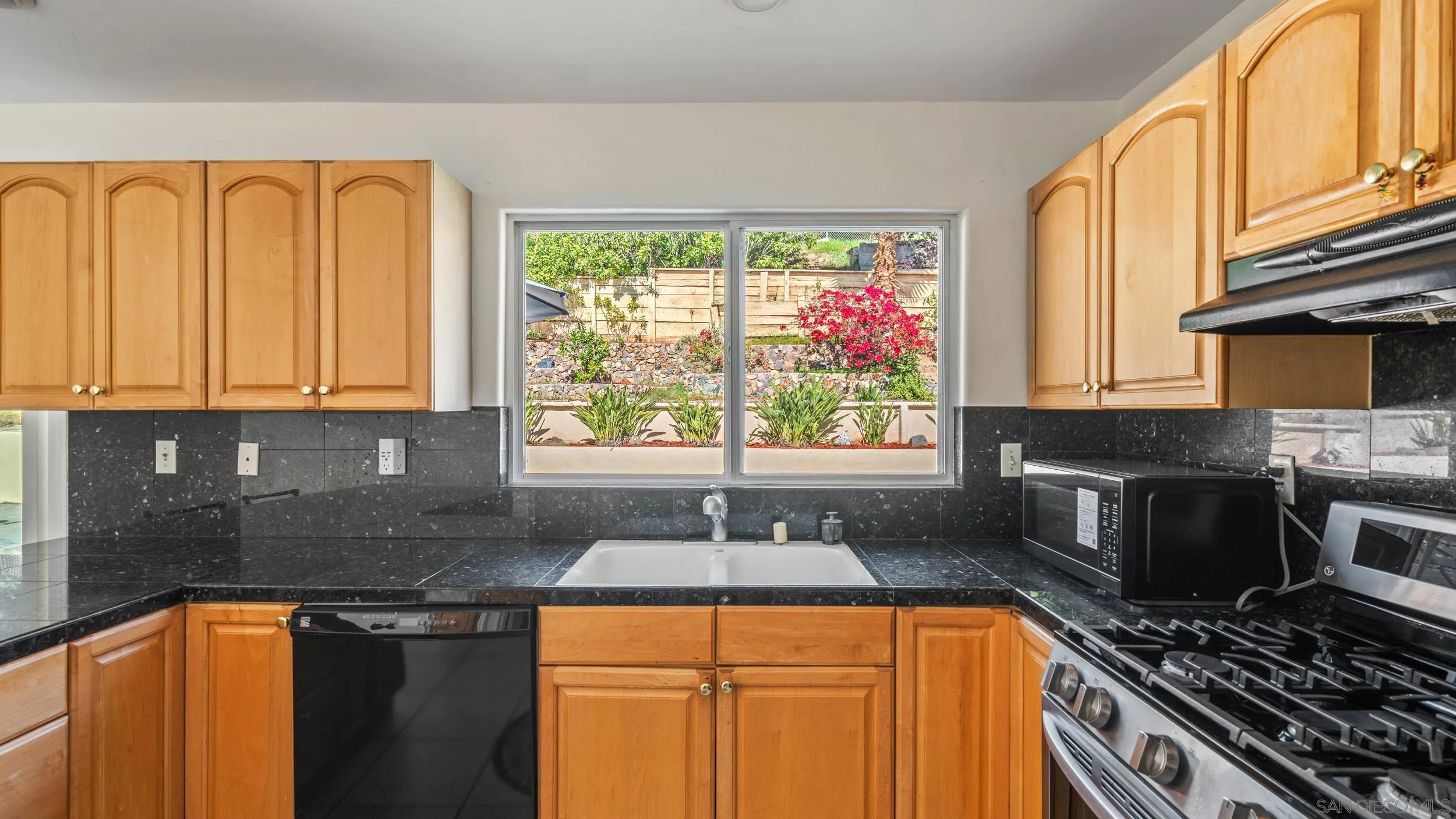 10019 Settle Road Santee, CA 92071 - Photo 15 of 35 a kitchen with stainless steel appliances granite countertop a sink stove and cabinets