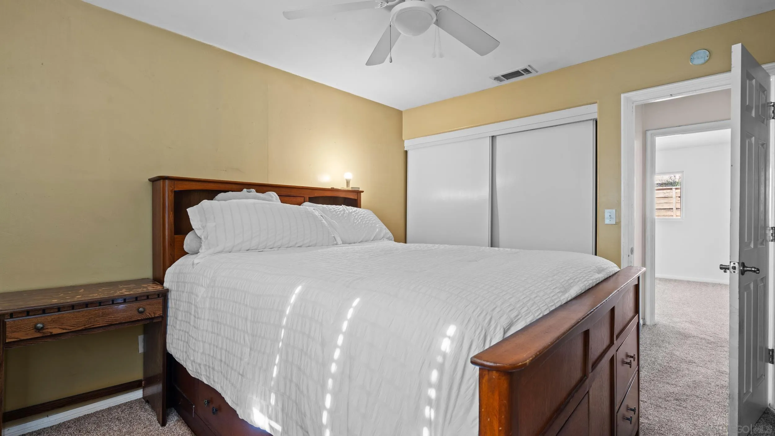 10019 Settle Road Santee, CA 92071 - Photo 20 of 35 a bedroom with a bed and a chandelier