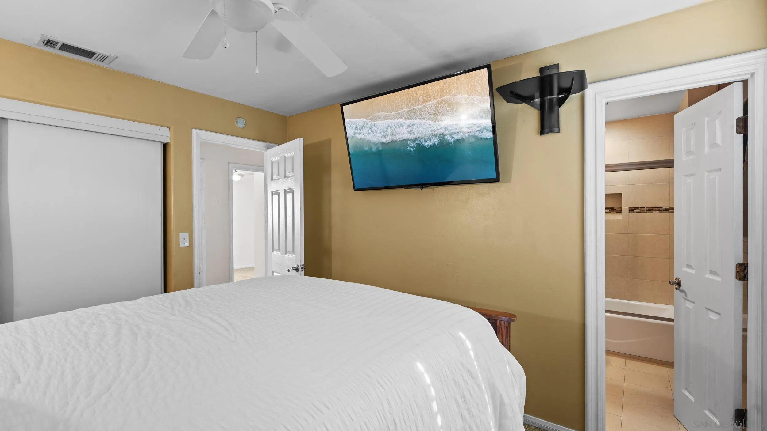 10019 Settle Road Santee, CA 92071 - Photo 21 of 35 a bedroom with a bed and a flat screen tv