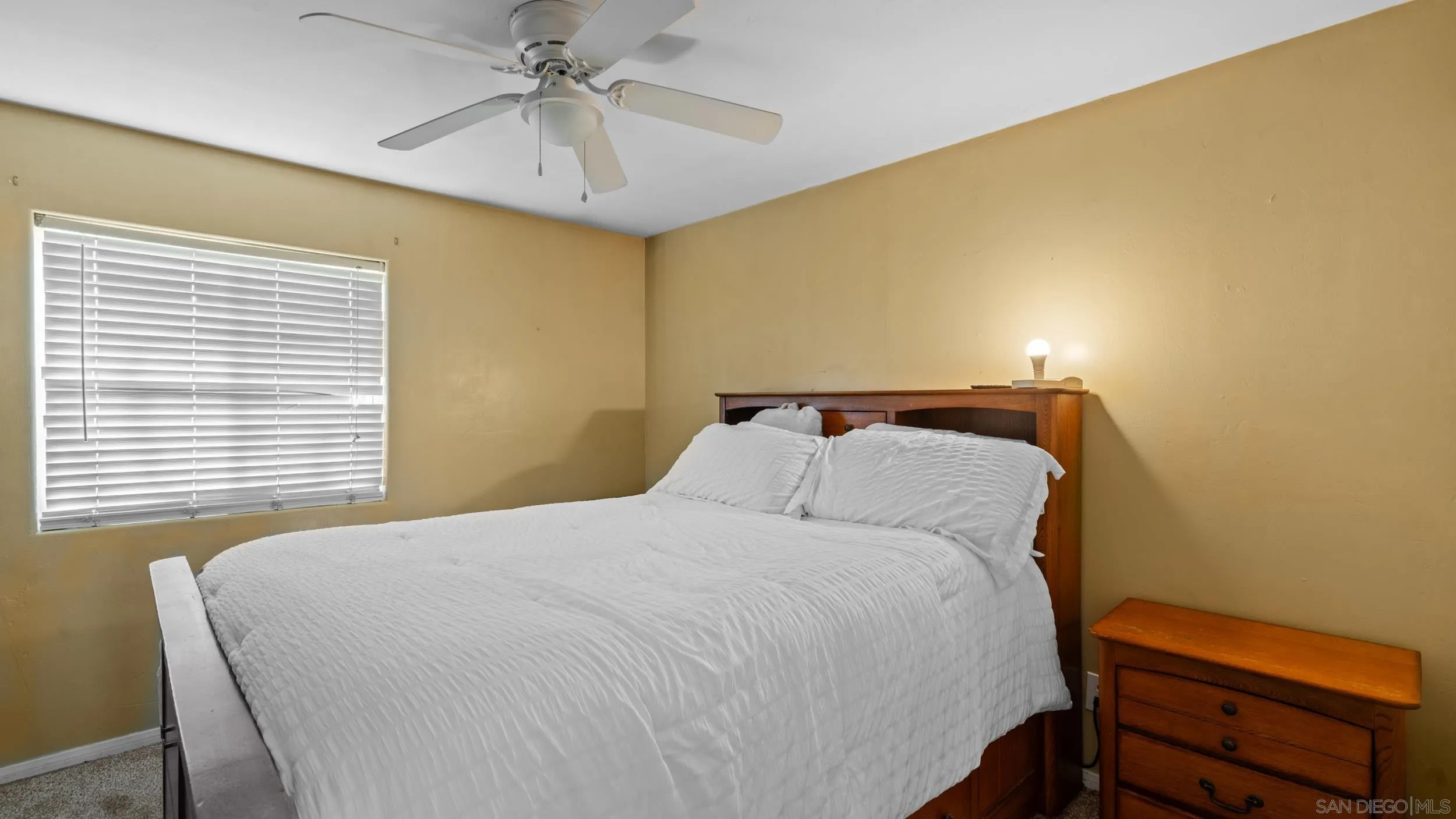 10019 Settle Road Santee, CA 92071 - Photo 23 of 35 a bedroom with a bed and a chandelier