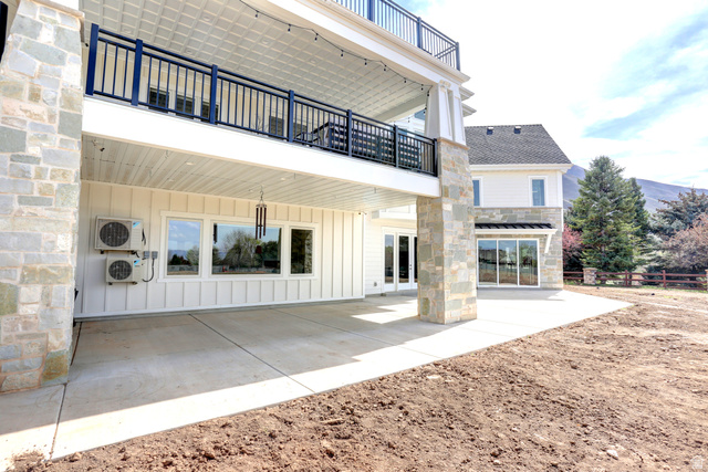 1354 South 800 East Mapleton, UT 84664 - Photo 123 of 129 Back of house with a balcony, board and batten siding, a patio, and stone siding