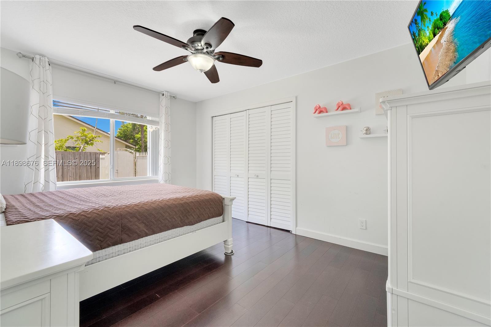 15300 Southwest 164th Street Miami, FL 33187 - Photo 13 of 39 a bedroom with a bed and a large window