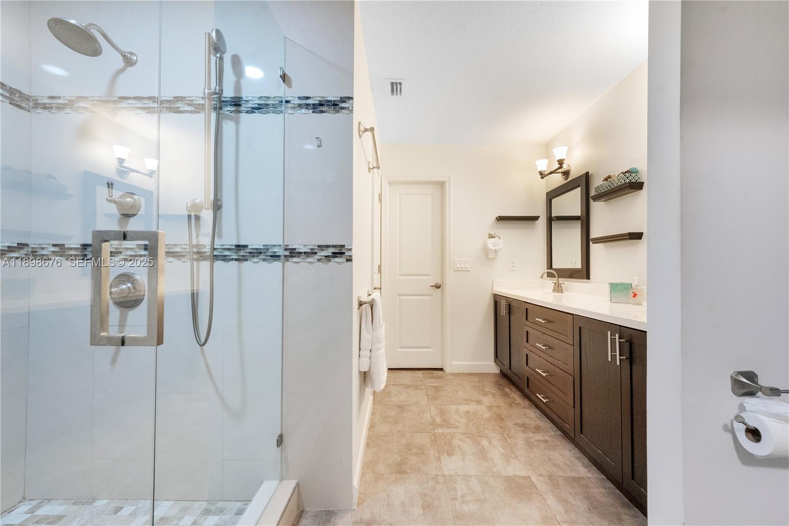 15300 Southwest 164th Street Miami, FL 33187 - Photo 18 of 39 a bathroom with a double vanity sink a mirror and shower