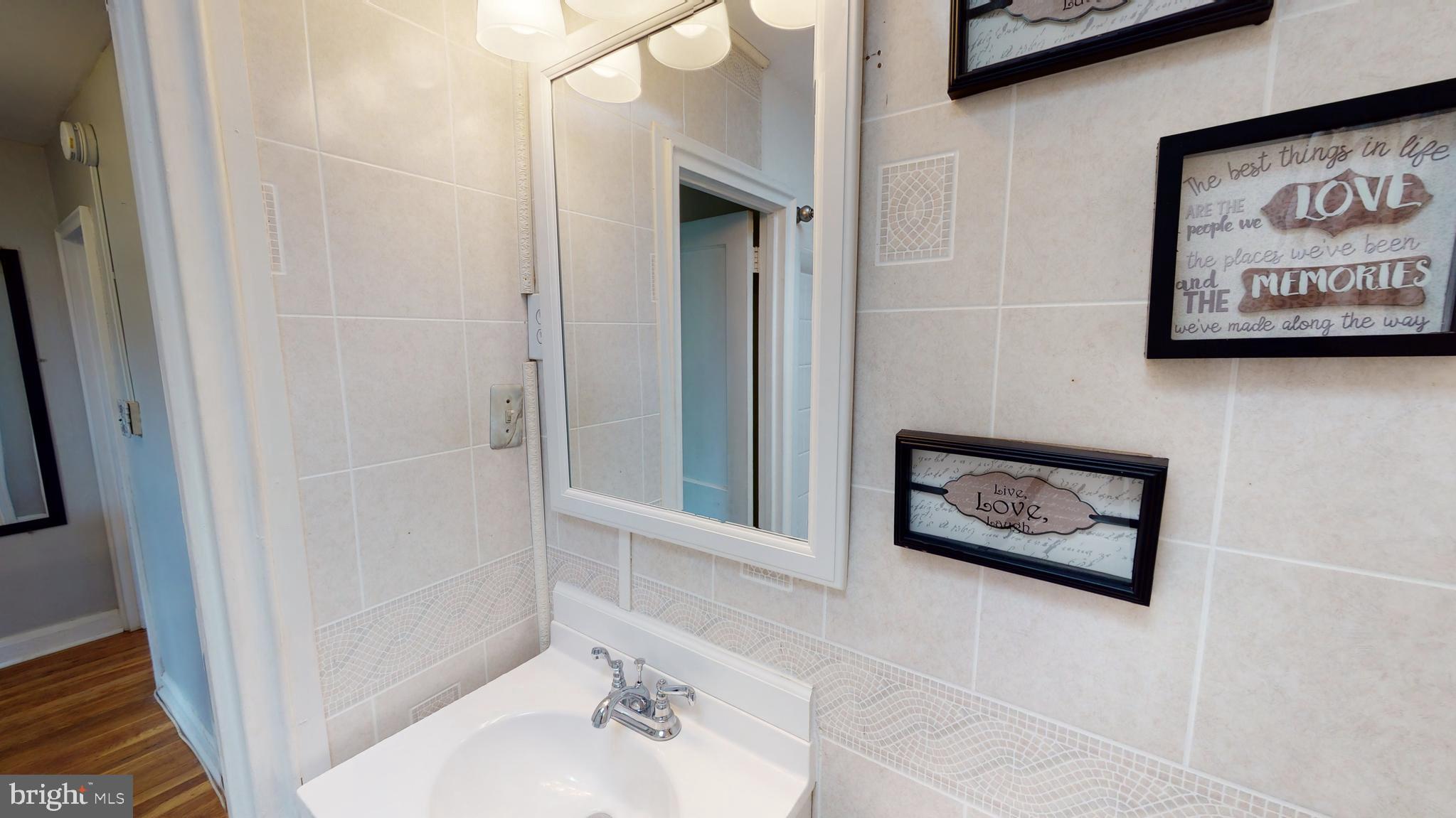 5438 Channing Road Baltimore, MD 21229 - Photo 18 of 20 a bathroom with a toilet and a shower