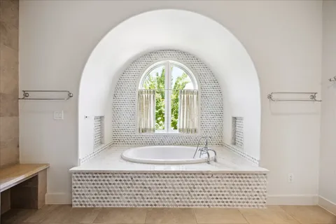 a bath room with a window and a table