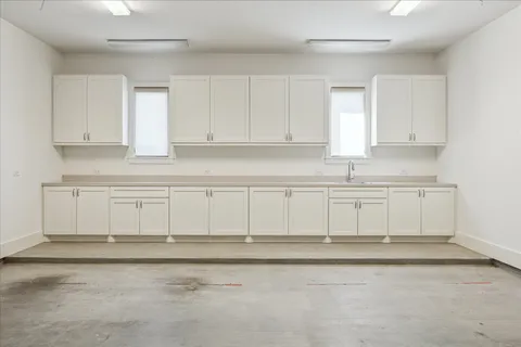 a view of a kitchen with white cabinets
