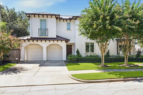 a white house with a yard and lawn chairs