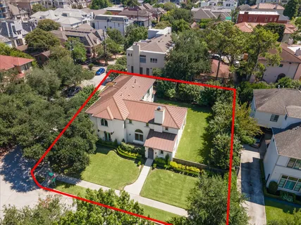 an aerial view of a house with a yard and lake view