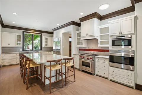 a kitchen with stainless steel appliances granite countertop a stove and a refrigerator