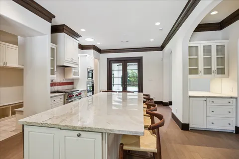a kitchen with a table chairs refrigerator and cabinets