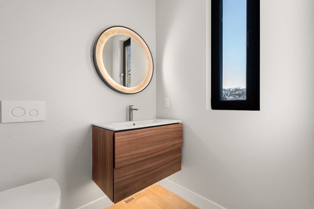 265 Varick Road Newton, MA 02468 - Photo 12 of 32 a bathroom with a sink and a mirror