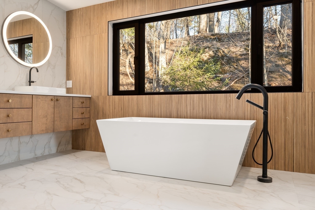 265 Varick Road Newton, MA 02468 - Photo 17 of 32 a white bath tub sitting in a bathroom