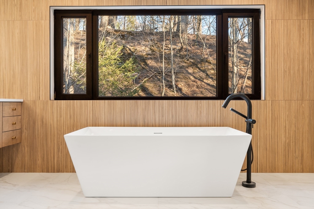 265 Varick Road Newton, MA 02468 - Photo 18 of 32 a white bath tub sitting in a bathroom next to a window