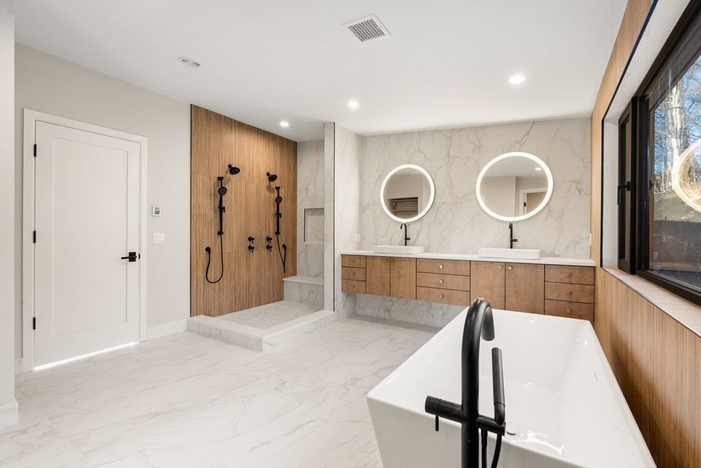 265 Varick Road Newton, MA 02468 - Photo 19 of 32 a spacious bathroom with a glass shower door and mirror