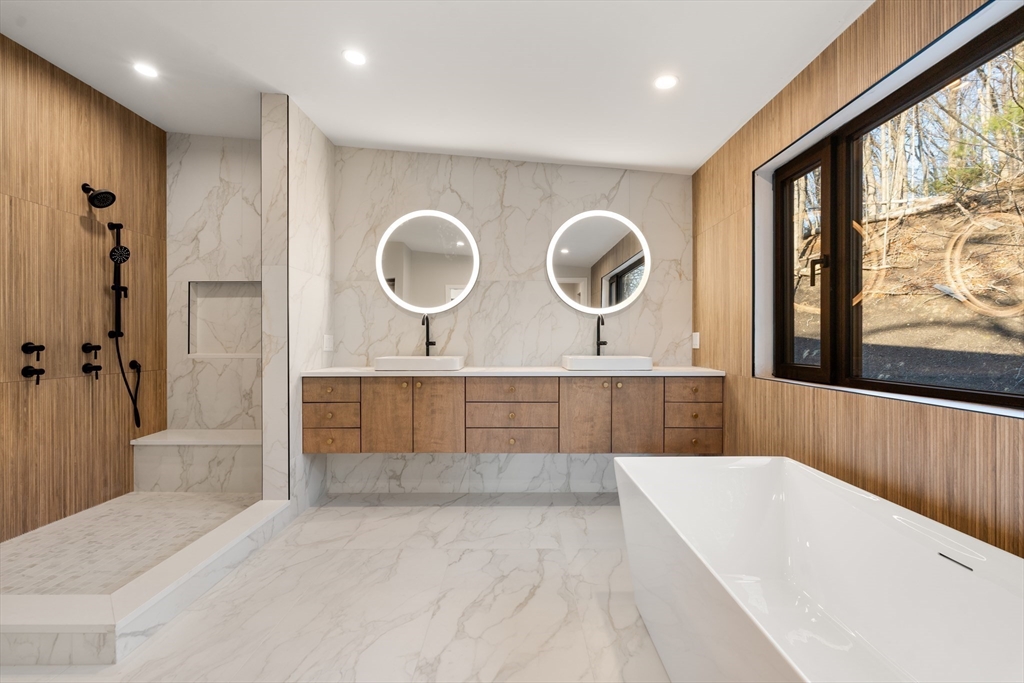 265 Varick Road Newton, MA 02468 - Photo 20 of 32 a bathroom with a tub a sink and a large window
