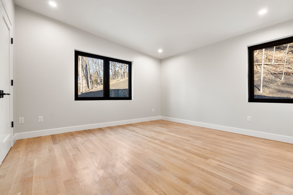 265 Varick Road Newton, MA 02468 - Photo 24 of 32 a view of an empty room with wooden floor and a window