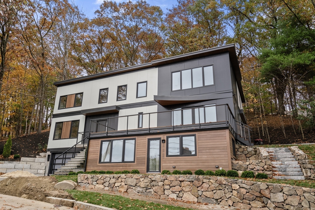 265 Varick Road Newton, MA 02468 - Photo 30 of 32 a front view of a house with garden