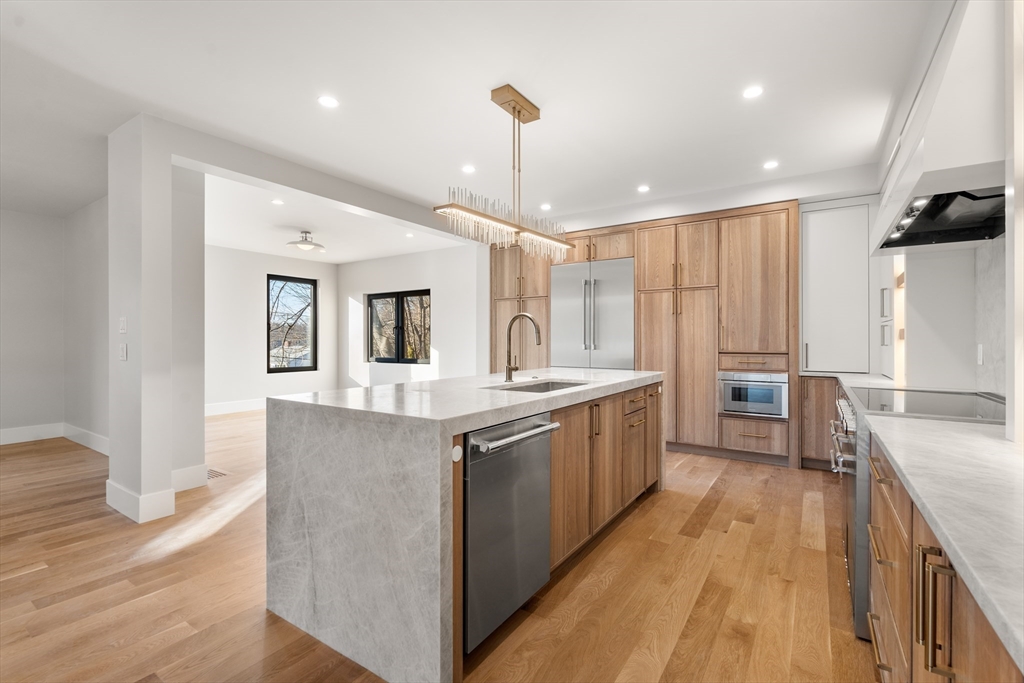 265 Varick Road Newton, MA 02468 - Photo 9 of 32 a kitchen with granite countertop a sink stove and refrigerator