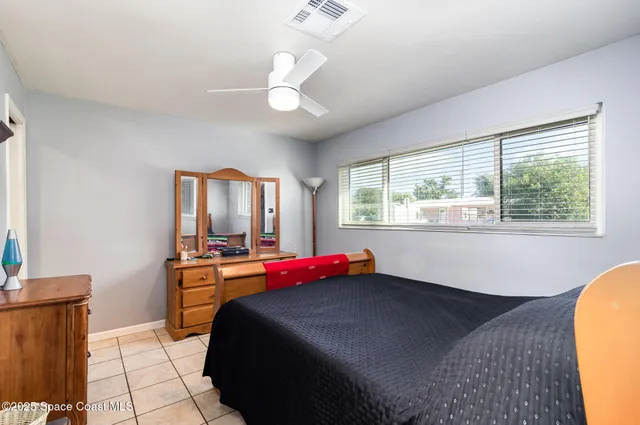 a bedroom with a bed and window