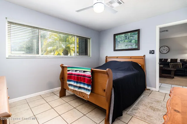 a bedroom with a bed and a painting on the wall