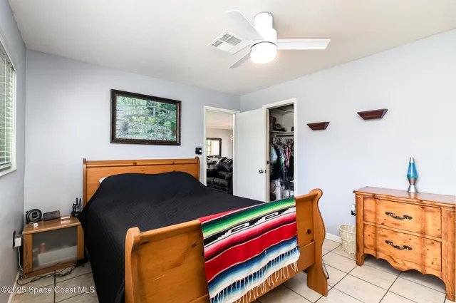 a bedroom with furniture and a chandelier
