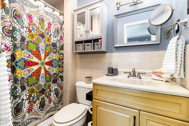 a bathroom with a sink mirror vanity and toilet