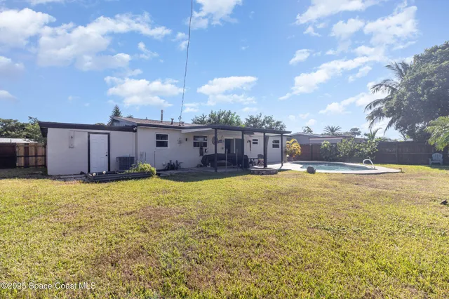 a swimming pool with outdoor seating and yard