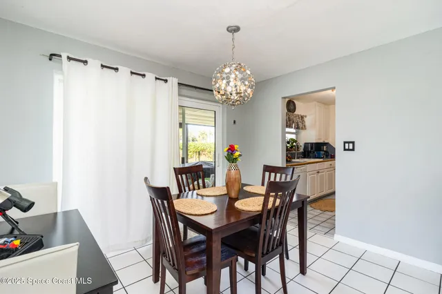 a view of a dining room with furniture and window