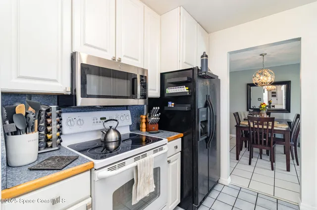 a kitchen with stainless steel appliances a microwave a sink a stove and cabinets