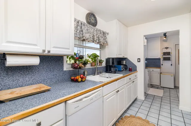 a kitchen with sink and cabinets