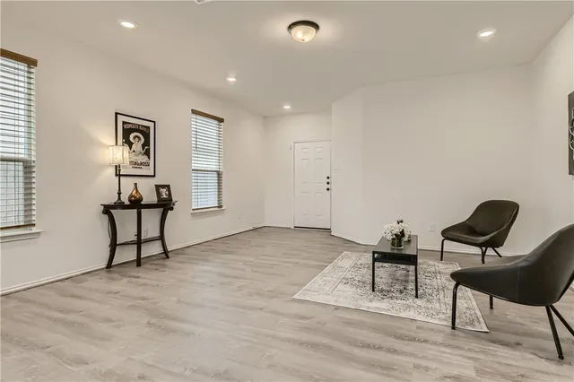 a living room with furniture and a piano