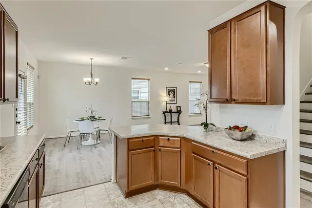 a kitchen with stainless steel appliances granite countertop a sink a stove and a refrigerator