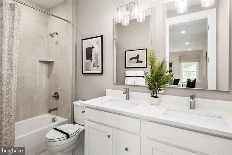 9415 Founders Lane Perry Hall, MD 21128 - Photo 20 of 27 a bathroom with a sink a toilet a mirror a bathtub and shower