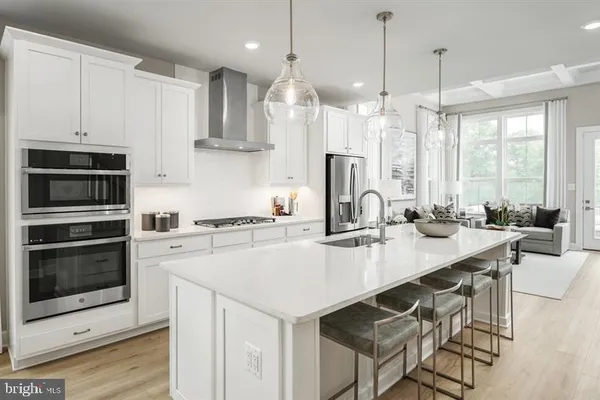 a kitchen with a stove a sink and a refrigerator