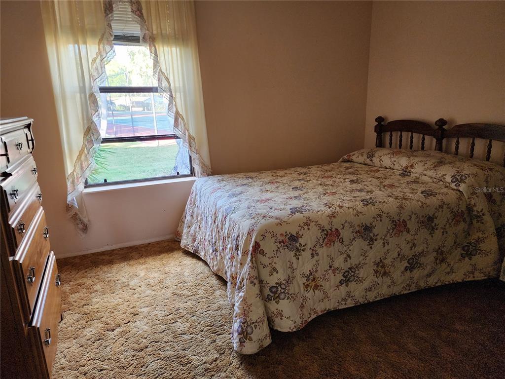 1206 Sawgrass Court Oldsmar, FL 34677 - Photo 10 of 10 a bed sitting in a bedroom next to a window