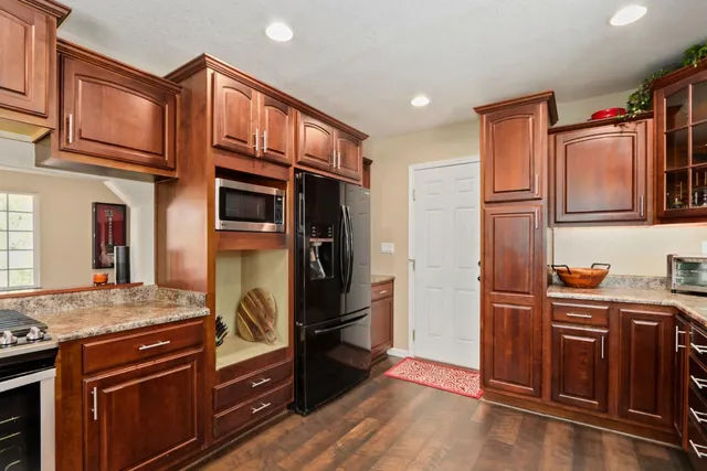 a kitchen with stainless steel appliances granite countertop a sink stove and refrigerator