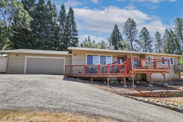 a view of a house with a yard and sitting area