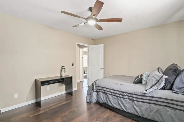 a bedroom with a large bed and a chandelier
