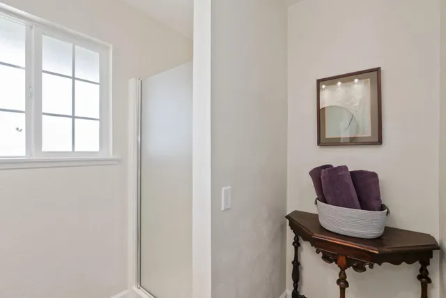 a view of room with wooden floor and mirror